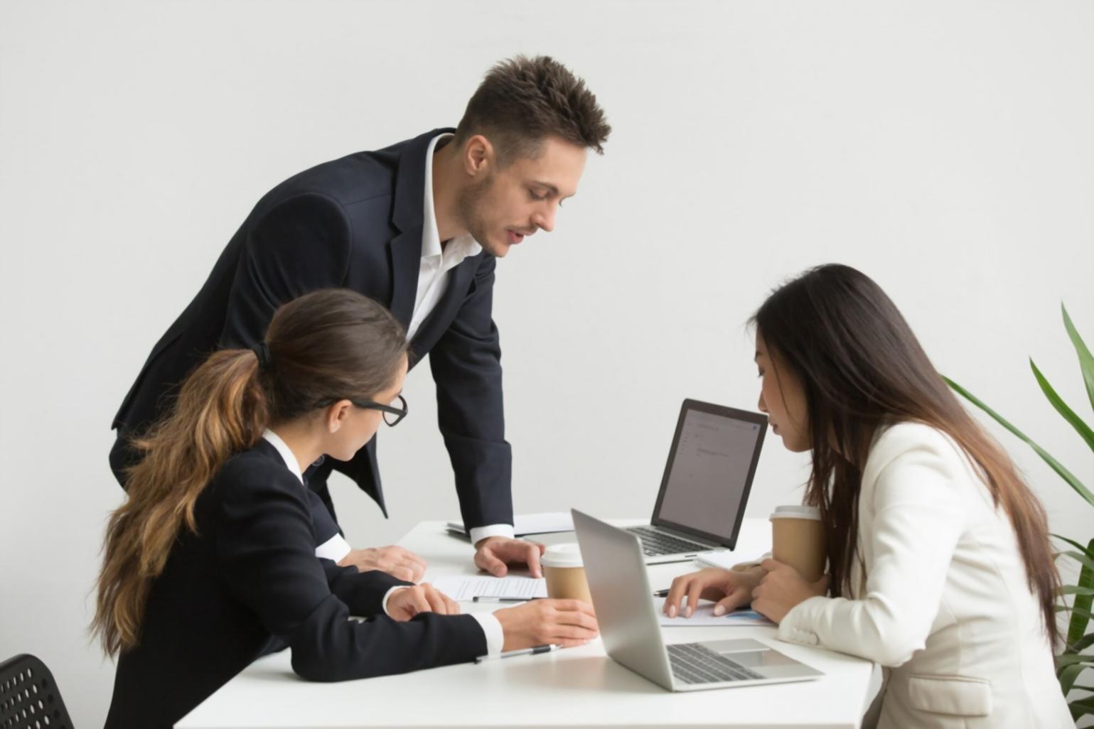Financial professional analyzing historical data trends on multiple monitors